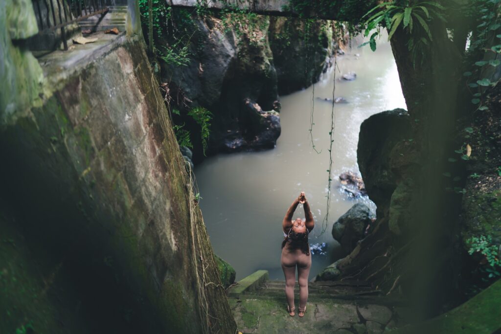 female standing in abundance mentality asana care about physical and mental health